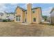 Backyard of this yellow home featuring a patio and ample yard space at 610 Maltese Dr, Atlanta, GA 30349