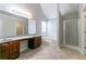 Primary bathroom features double vanity, soaking tub, and glass shower at 610 Maltese Dr, Atlanta, GA 30349