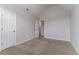 A neutral-colored bedroom offers plush carpeting, neutral walls, and a closet with bright white doors at 610 Maltese Dr, Atlanta, GA 30349