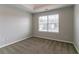 An airy bedroom features soft carpeting, a bright window, and a tray ceiling at 610 Maltese Dr, Atlanta, GA 30349