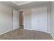 This airy bedroom offers soft carpeting, a closet, and neutral paint throughout at 610 Maltese Dr, Atlanta, GA 30349