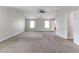 Large primary bedroom with neutral colors and carpeted floors at 610 Maltese Dr, Atlanta, GA 30349