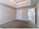 This spacious carpeted bedroom has a closet, a tray ceiling, and neutral paint at 610 Maltese Dr, Atlanta, GA 30349