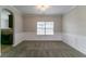 A neutral dining room with carpet, white wainscotting and a window for natural light at 610 Maltese Dr, Atlanta, GA 30349