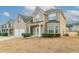 Exterior shot of a two-story brick home with a two-car garage and manicured front bushes at 610 Maltese Dr, Atlanta, GA 30349