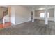 Open concept living room with plush carpet, white column accents and plenty of natural light at 610 Maltese Dr, Atlanta, GA 30349