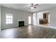 Inviting living room features wood floors, fireplace, and entry to kitchen at 610 Maltese Dr, Atlanta, GA 30349