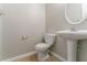 Classic powder room with pedestal sink and neutral finishes at 610 Maltese Dr, Atlanta, GA 30349