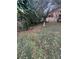 Landscaped backyard with mature trees and a bird bath, creating a serene outdoor space at 1046 Sans Souci Way, Clarkston, GA 30021