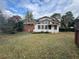 Expansive backyard featuring a home with a screened-in porch and ample space for outdoor activities at 1046 Sans Souci Way, Clarkston, GA 30021