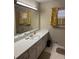 Bathroom with an extended counter space, a large mirror, and yellow floral curtains at 1046 Sans Souci Way, Clarkston, GA 30021