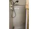 Tiled bathroom with shower head and curtain at 1046 Sans Souci Way, Clarkston, GA 30021