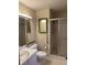 Bathroom features a glass-enclosed shower, grab bars, and a neutral color palette at 1046 Sans Souci Way, Clarkston, GA 30021