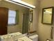 Bathroom featuring a large mirror, a window with curtains, and grab bars at 1046 Sans Souci Way, Clarkston, GA 30021