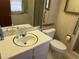 Bathroom featuring a large mirror, a single sink, and a window with curtains at 1046 Sans Souci Way, Clarkston, GA 30021