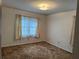 Bedroom with large window and carpeted floor at 1046 Sans Souci Way, Clarkston, GA 30021