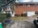 View of home's exterior with brick facade, driveway, and garage, showcasing its curb appeal and parking features at 1046 Sans Souci Way, Clarkston, GA 30021
