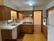 Functional kitchen featuring wood cabinets, modern appliances and a seamless transition to the adjacent dining area at 1046 Sans Souci Way, Clarkston, GA 30021