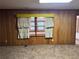 Spacious living room features wood paneled walls and a large window at 1046 Sans Souci Way, Clarkston, GA 30021