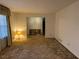 Bright living room featuring neutral walls, a large window, and carpeted floor at 1046 Sans Souci Way, Clarkston, GA 30021