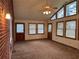 Bright living room featuring a wall of windows, a ceiling fan and neutral carpeting at 1046 Sans Souci Way, Clarkston, GA 30021