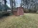 Backyard view featuring a wooden storage shed, providing convenient and accessible outdoor storage at 1046 Sans Souci Way, Clarkston, GA 30021