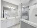 Bathroom featuring double sinks, a large mirror and glass enclosed shower with bench at 4203 Stratford Commons # 4203, Decatur, GA 30033