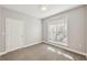 Carpeted bedroom featuring a single window with blinds at 4203 Stratford Commons # 4203, Decatur, GA 30033