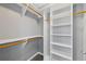 Organized walk-in closet with built-in shelving and hanging rods at 4203 Stratford Commons # 4203, Decatur, GA 30033