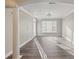 Bright and airy living room with large windows and hardwood floors with modern light fixture at 4203 Stratford Commons # 4203, Decatur, GA 30033