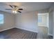 A clean, bright bedroom features wood-look floors, a ceiling fan, and neutral paint at 645 Plainville Sw Dr, Atlanta, GA 30331
