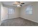 Bedroom with fan, plush carpet, and natural light from two windows at 645 Plainville Sw Dr, Atlanta, GA 30331