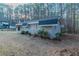 Side view of a brick home with a dark roof and small bushes around the perimeter at 645 Plainville Sw Dr, Atlanta, GA 30331