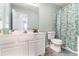 A charming bathroom with a white vanity, decorative shower curtain, and modern fixtures at 1176 Whatley Mill Ln, Lawrenceville, GA 30045