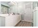 Bathroom featuring double vanity sink, linen closet, and updated cabinets at 1176 Whatley Mill Ln, Lawrenceville, GA 30045