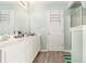 Bathroom featuring double vanity sink, linen closet, and updated cabinets at 1176 Whatley Mill Ln, Lawrenceville, GA 30045