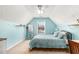 A cozy room featuring blue walls, a large window for natural light, and a comfortable bed with a blue comforter at 1176 Whatley Mill Ln, Lawrenceville, GA 30045