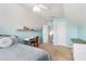 A cozy room featuring blue walls, a large window for natural light, a desk with a chair and shelves at 1176 Whatley Mill Ln, Lawrenceville, GA 30045