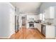 Bright kitchen with white cabinetry, stainless steel appliances, subway tile backsplash, and light hardwood flooring at 1176 Whatley Mill Ln, Lawrenceville, GA 30045