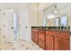 Elegant bathroom featuring double vanities, granite countertops, and stylish tile flooring at 2685 Lenora Church Rd, Snellville, GA 30078