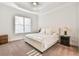 Bright bedroom with neutral carpet, tray ceiling, and modern lamps at 2685 Lenora Church Rd, Snellville, GA 30078