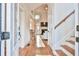 Inviting foyer with hardwood floors, a view into the living room, and staircase at 2685 Lenora Church Rd, Snellville, GA 30078