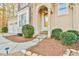 Close-up of the front entrance with a stone pathway, elegant doorway, and manicured bushes at 2685 Lenora Church Rd, Snellville, GA 30078