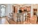 Kitchen bar features custom cabinetry, granite countertops, pendant lighting and stainless steel appliances at 2685 Lenora Church Rd, Snellville, GA 30078