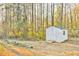 Exterior view of shed on a verdant lawn with treeline backdrop and garden features at 2685 Lenora Church Rd, Snellville, GA 30078