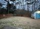 Spacious backyard featuring lush greenery, a privacy fence, and ample space for recreation at 310 Creekside Trl, Covington, GA 30016