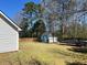 Backyard featuring a shed, trees, and boat at 310 Creekside Trl, Covington, GA 30016