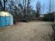 Large backyard featuring a storage shed and ample space for outdoor activities at 310 Creekside Trl, Covington, GA 30016