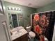 Cozy bathroom with a vanity sink, toilet, and a shower with sunflower curtains at 310 Creekside Trl, Covington, GA 30016