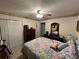 Bedroom featuring ceiling fan, closet space, dresser and cozy patterned bedding at 310 Creekside Trl, Covington, GA 30016